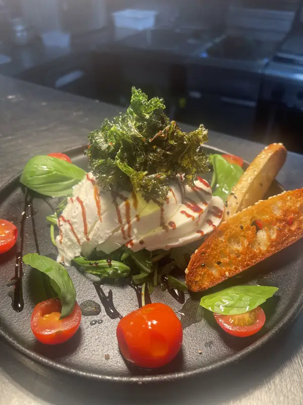 Caprese di bufala with cherry tomatoes and basil at Mascalzone Altona