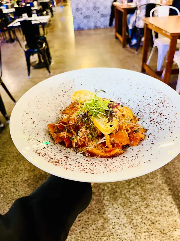 Spinach and ricotta ravioli in napoli sauce with mushroom and pancetta